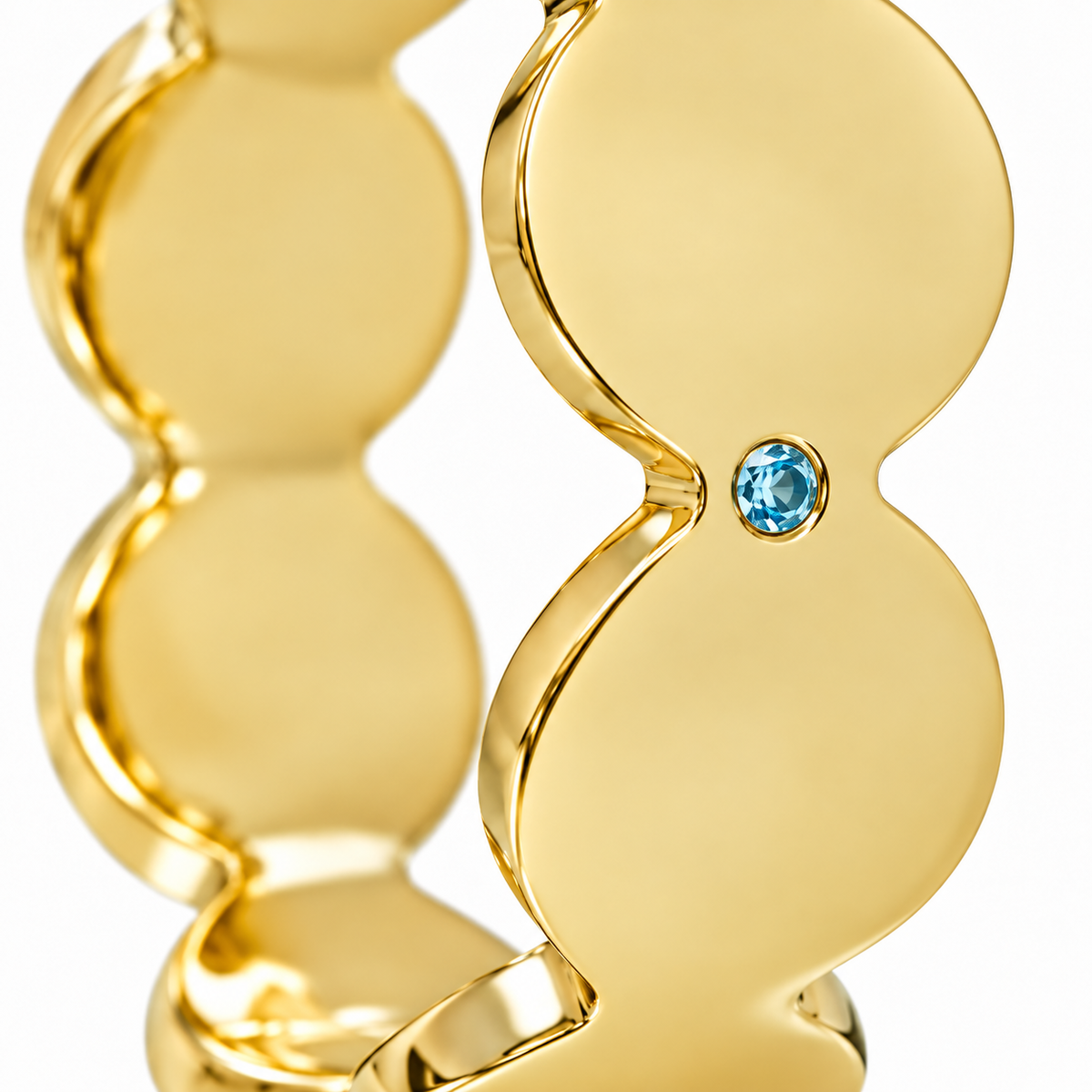 Close-up of round-cut blue topaz gypsy setting on Azure Rhythm Band Sterling Silver & 18K Gold Plated by Bed of Stones Jewelry