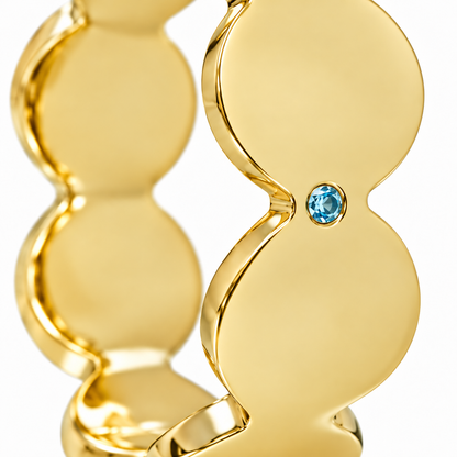 Close-up of round-cut blue topaz gypsy setting on Azure Rhythm Band Sterling Silver & 18K Gold Plated by Bed of Stones Jewelry