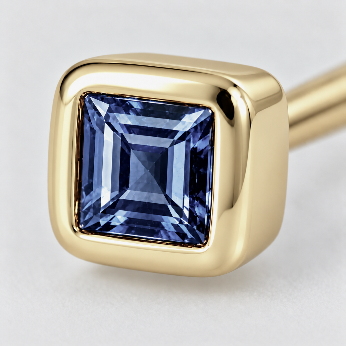 Close-up of blue sapphire bezel setting on Blue Whisper Earrings by Bed of Stones Jewelry