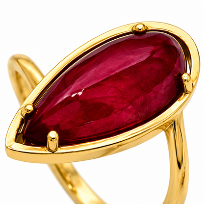 Close-up of pear-cut Indian ruby prong setting on Crimson Almond 18K Gold Ring by Bed of Stones Jewelry
