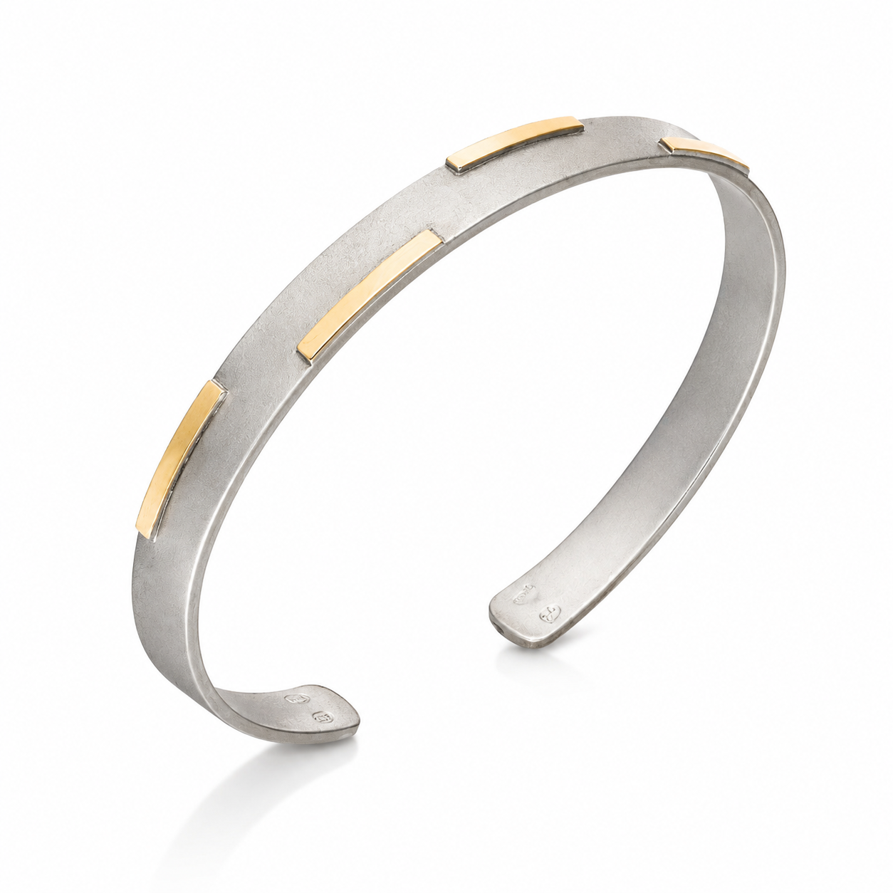 Sterling silver open cuff bracelet with polished 18K gold stripe accents on a white background.