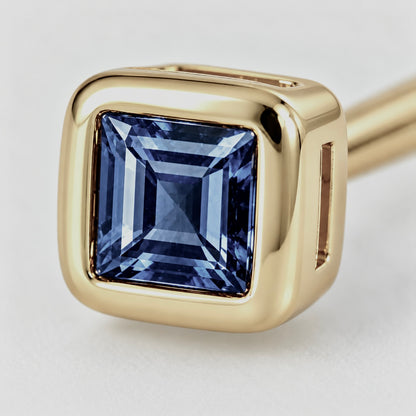 Close-up of blue sapphire bezel setting on Blue Whisper Earrings by Bed of Stones Jewelry