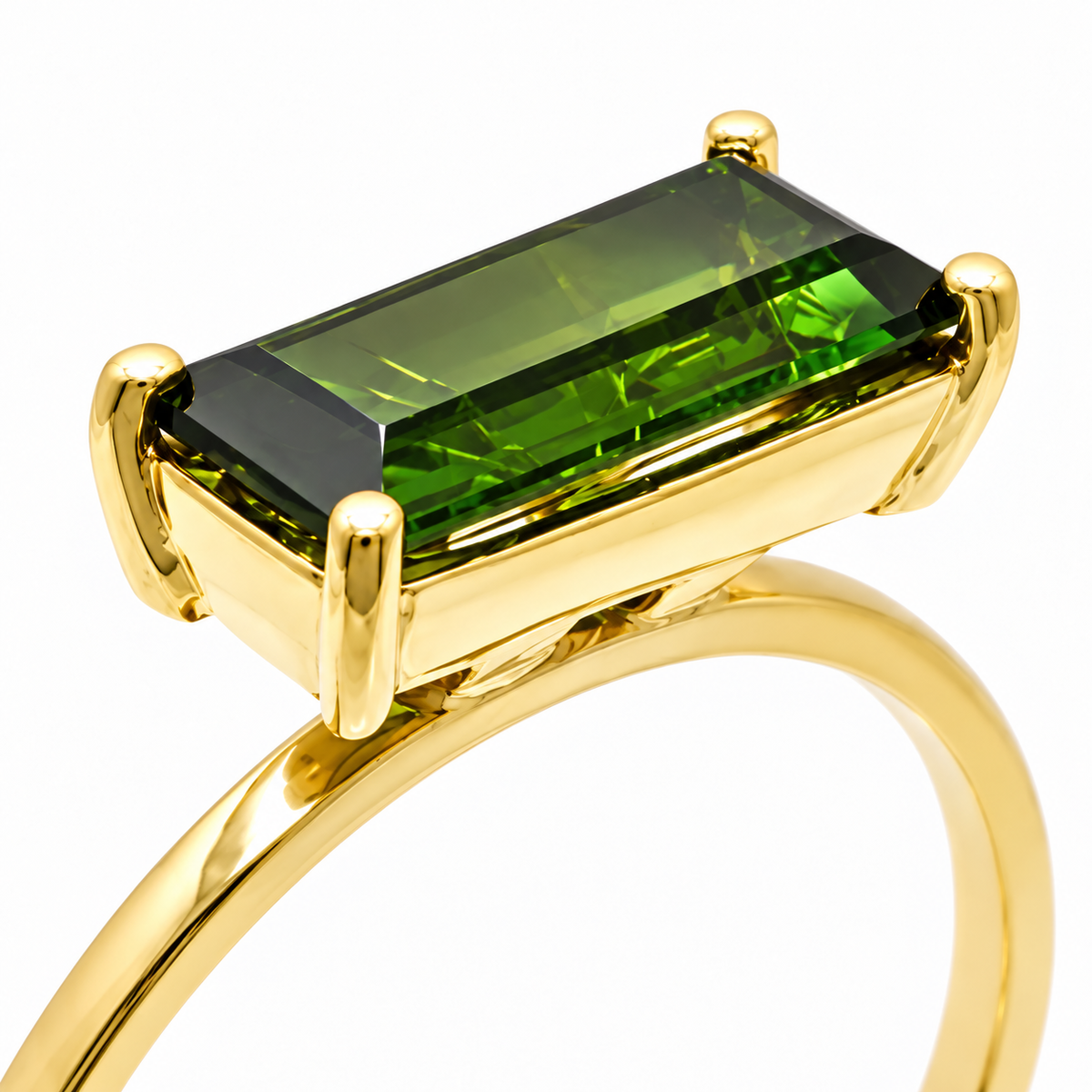 Close-up of baguette-cut green tourmaline prong setting on Golden Geometry 18K Gold Ring by Bed of Stones Jewelry