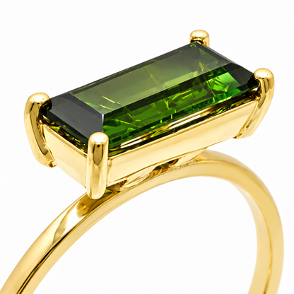 Close-up of baguette-cut green tourmaline prong setting on Golden Geometry 18K Gold Ring by Bed of Stones Jewelry