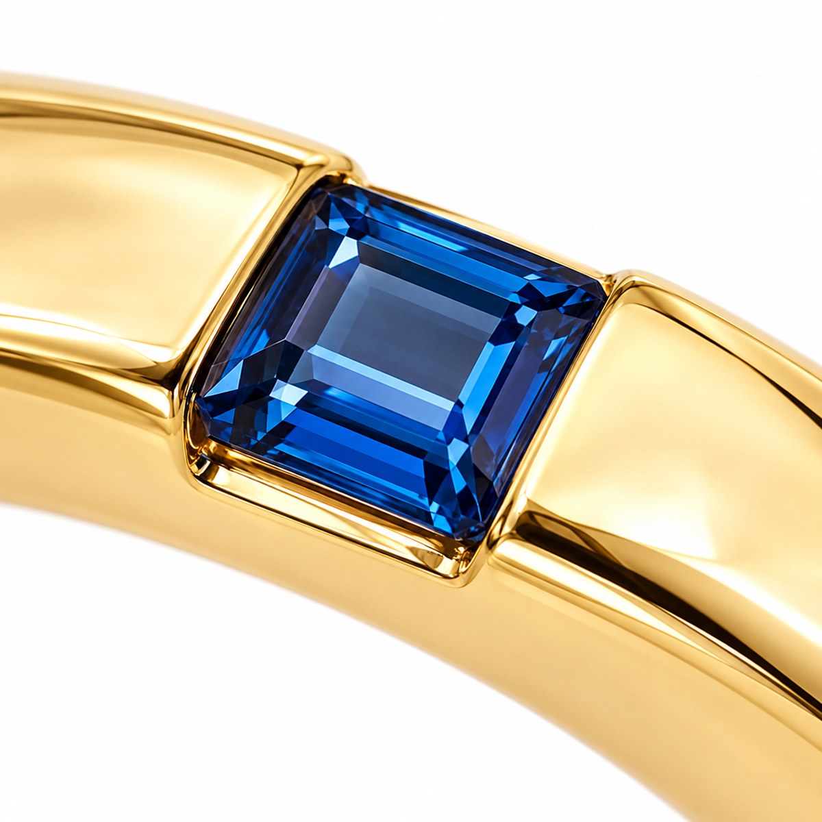 Close-up of princess-cut blue sapphire gypsy setting on Hidden Spark 18K Gold Ring by Bed of Stones Jewelry