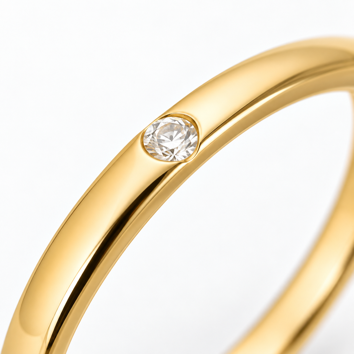 Close-up of round-cut white diamond gypsy setting on Hidden Spark 18K Gold Ring by Bed of Stones Jewelry