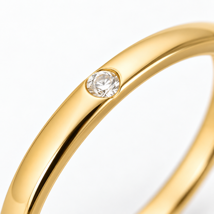 Close-up of round-cut white diamond gypsy setting on Hidden Spark 18K Gold Ring by Bed of Stones Jewelry