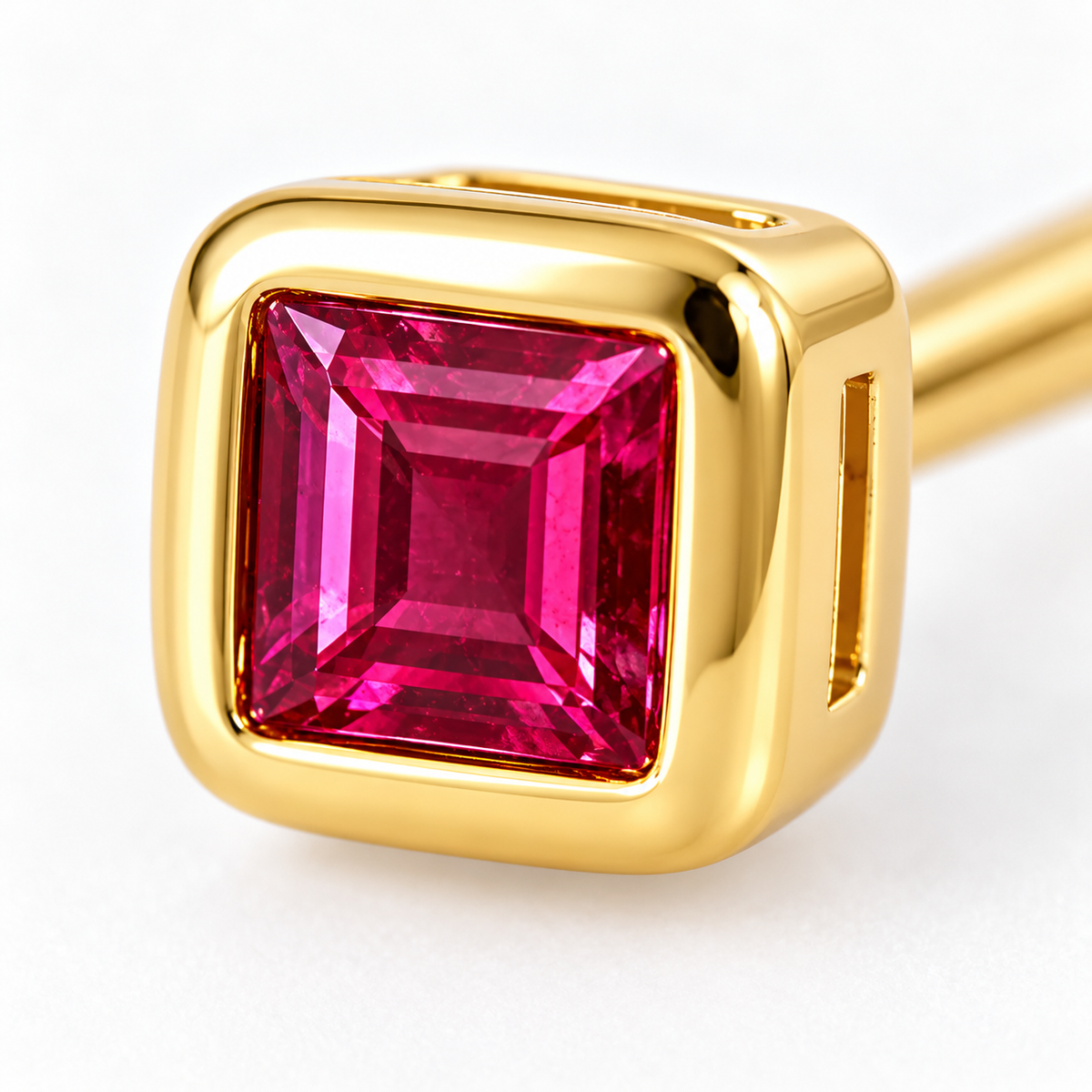 Close-up of ruby bezel setting on Rose Spark Earrings by Bed of Stones Jewelry