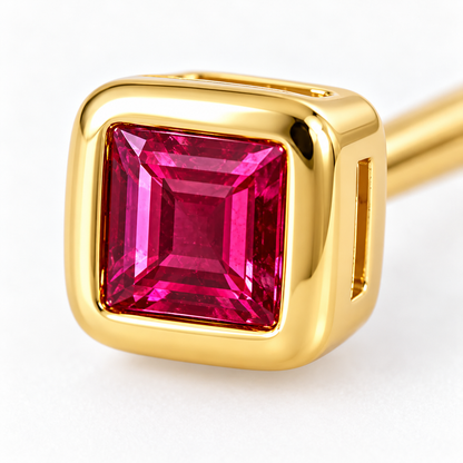 Close-up of ruby bezel setting on Rose Spark Earrings by Bed of Stones Jewelry