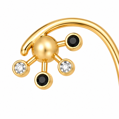 Close-up of black and white diamond bezel setting on Nova Loop 18K Gold Ear Cuff by Bed of Stones Jewelry
