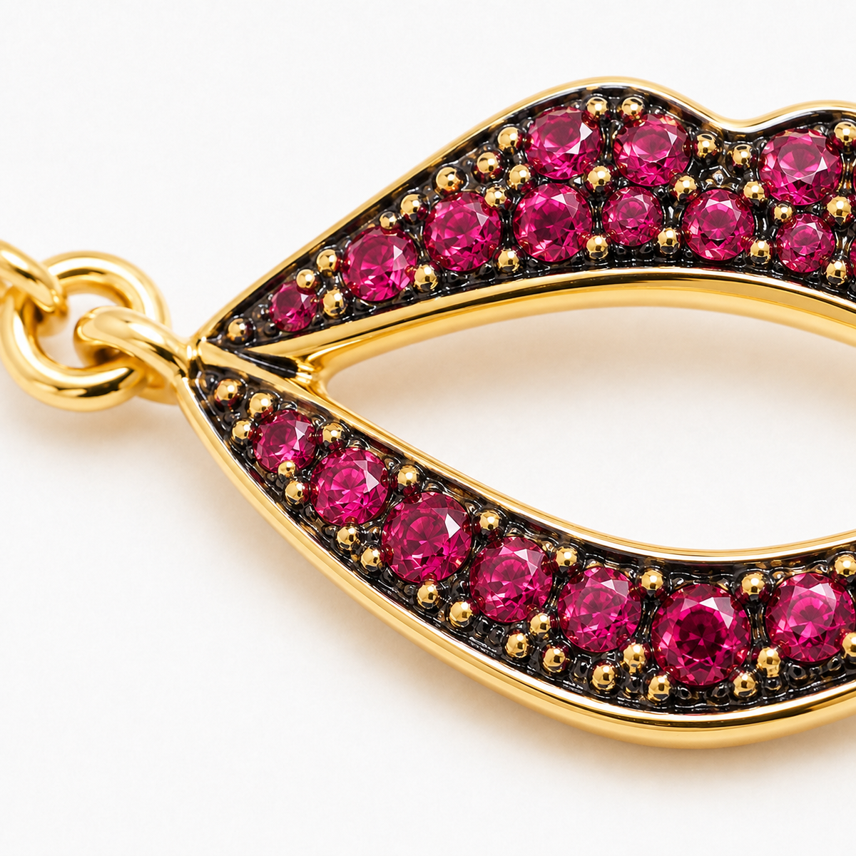 Close-up of ruby pavé lips charm on Lip Luxe Open Allure 18K Gold Bracelet by Bed of Stones Jewelry