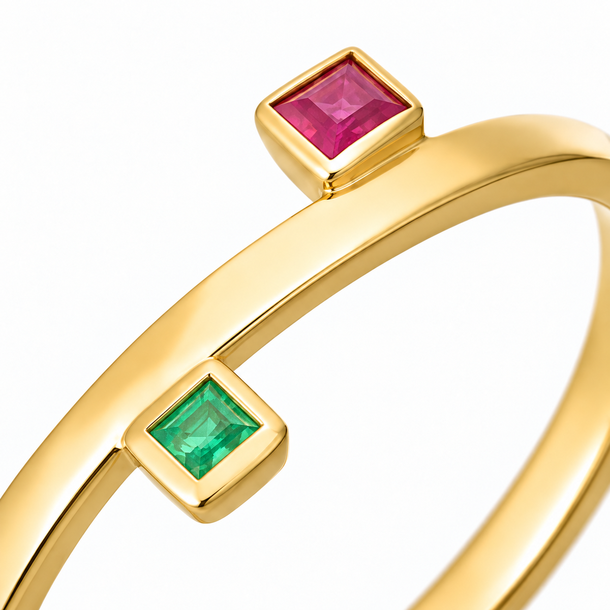 Close-up of princess-cut ruby and emerald bezel setting on Motion Squares 18K Gold Ring by Bed of Stones Jewelry