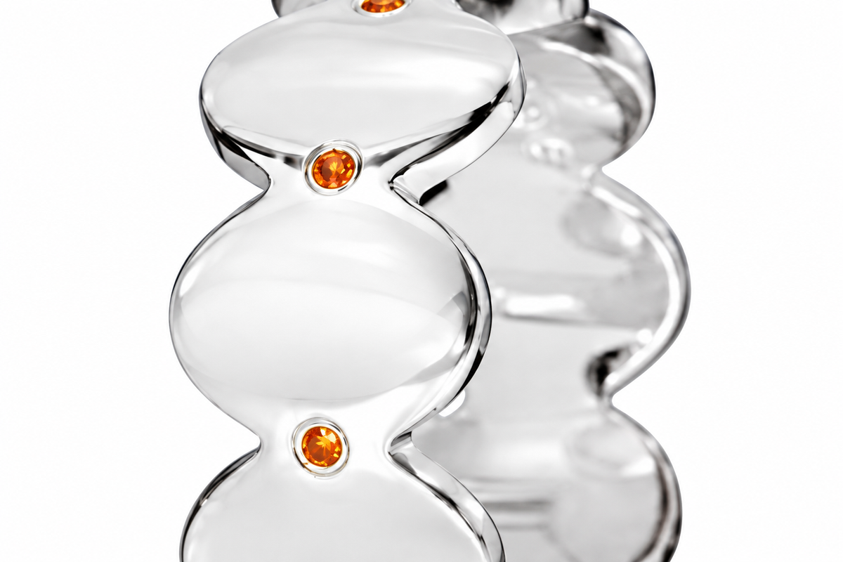 Close-up of round-cut orange sapphire gypsy setting on Orange Echo Band Sterling Silver by Bed of Stones Jewelry