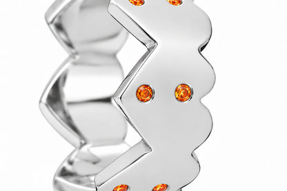 Close-up of round-cut orange sapphire gypsy setting on Orange Echo Heart Band Sterling Silver by Bed of Stones Jewelry