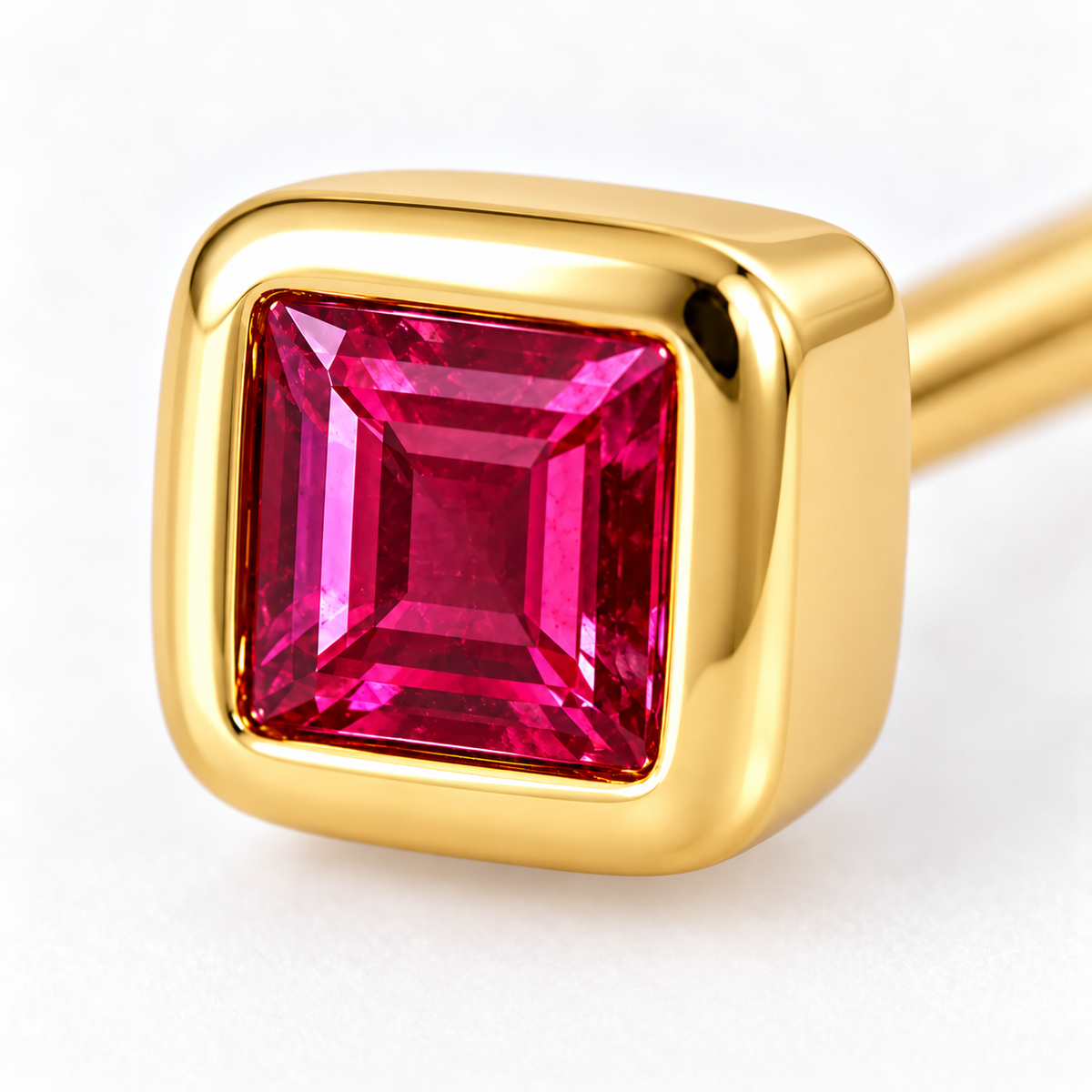 Close-up of ruby bezel settine Spark Earrings by Bed of Stones jewelry