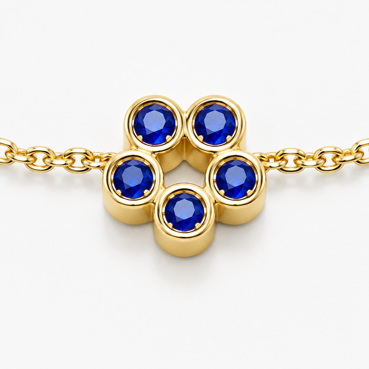 Close-up of blue sapphire bezel setting on Rosette 18K Gold Bracelet by Bed of Stones Jewelry