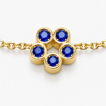 Close-up of blue sapphire bezel setting on Rosette 18K Gold Bracelet by Bed of Stones Jewelry