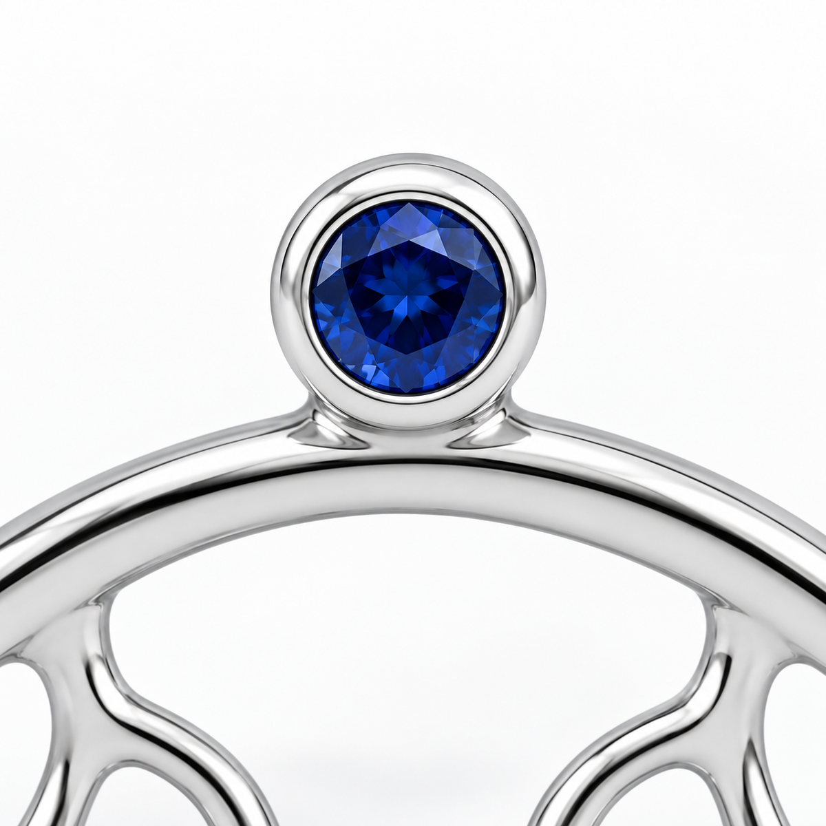 Close-up of blue sapphire bezel setting on Silver Swing Stud Earrings by Bed of Stones Jewelry