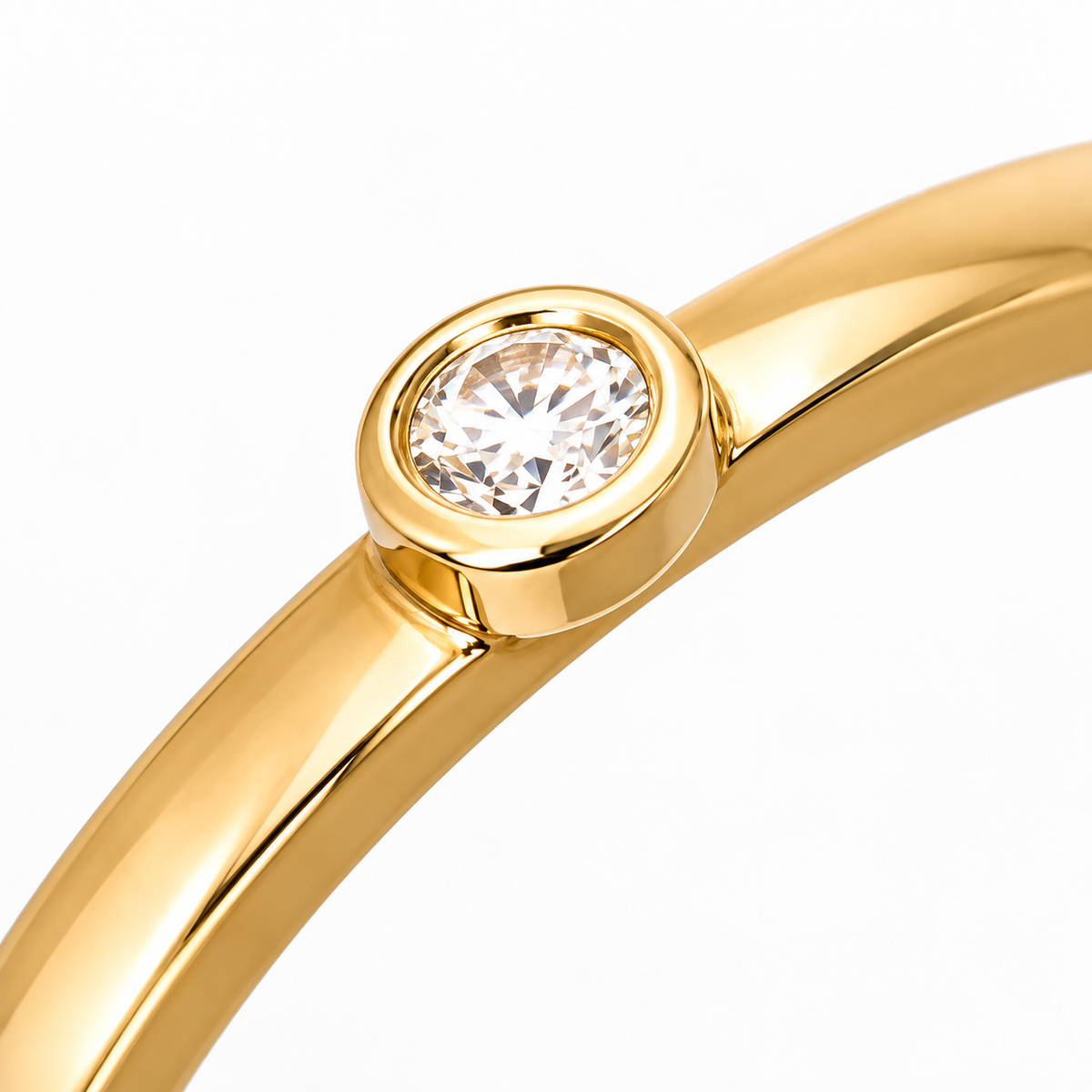 Close-up of round-cut white diamond bezel setting on Solo Dot 18K Gold Ring by Bed of Stones Jewelry