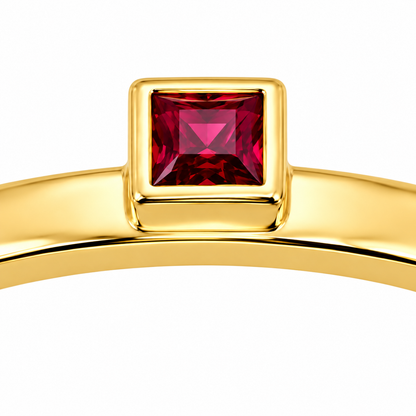 Close-up of princess-cut ruby bezel setting on Solo Square 18K Gold Ring by Bed of Stones Jewelry