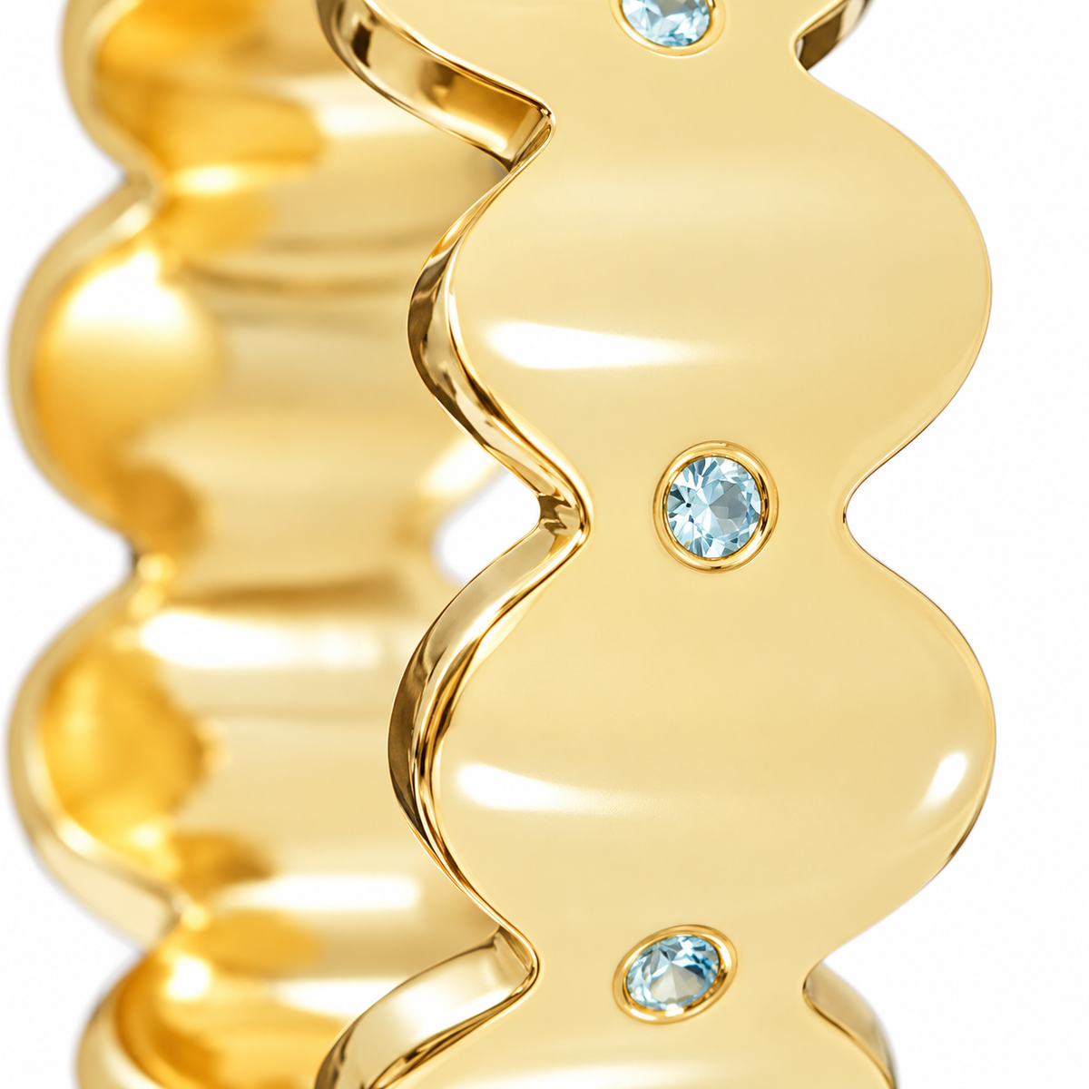 Close-up of round-cut blue topaz gypsy setting on Topaz Edge Band Sterling Silver & 18K Gold Plated by Bed of Stones Jewelry