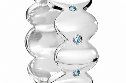 Close-up of round-cut blue topaz gypsy setting on Topaz Edge Band Sterling Silver & Platinum Plated by Bed of Stones Jewelry