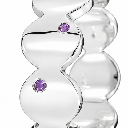Close-up of round-cut amethyst gypsy setting on Violet Rhythm Band Sterling Silver by Bed of Stones Jewelry